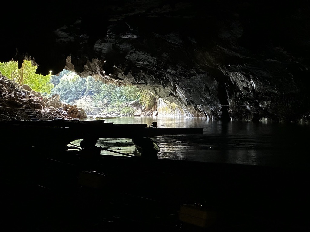 Walkway and rock formations in the lit chamber of Kong Lor Cave, Laos