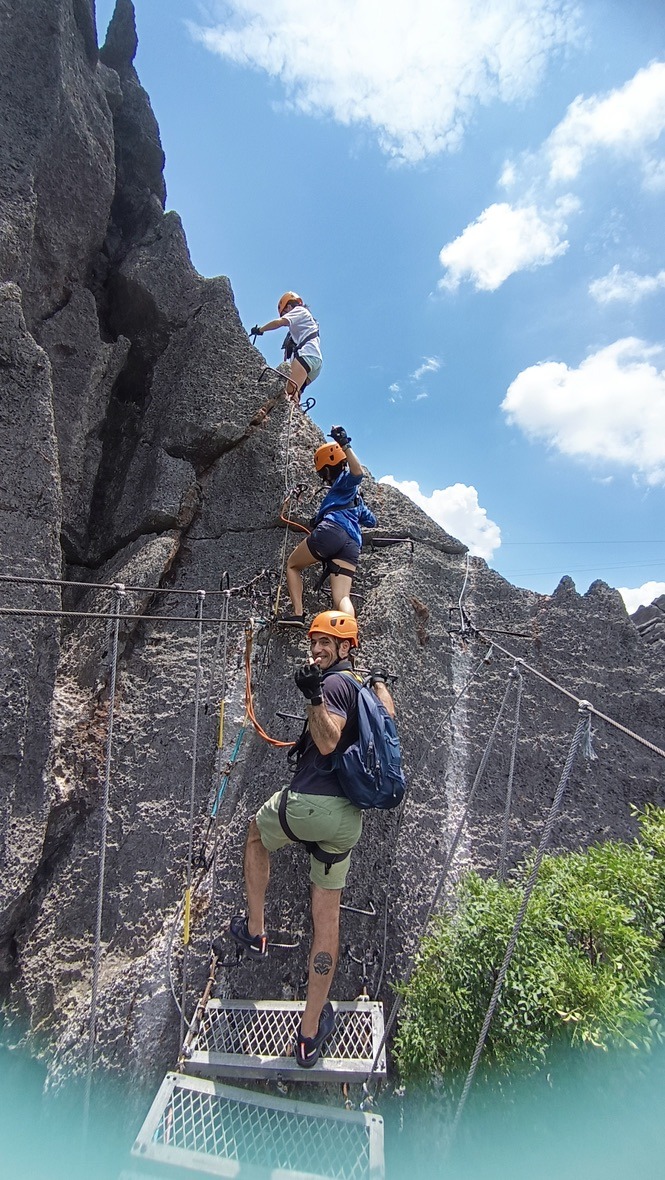 Climbers on the via ferrata at The Rock Viewpoint, Phou Pha Marn, Laos
