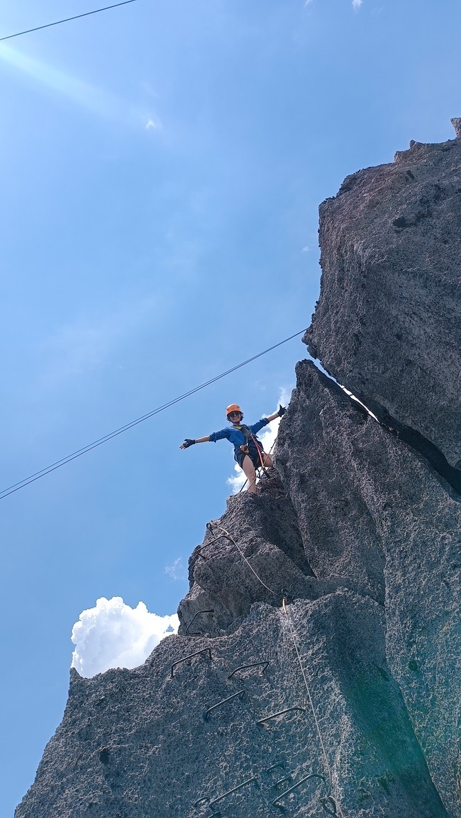 Traveller on top of a limestone spire at The Rock Viewpoint, Laos
